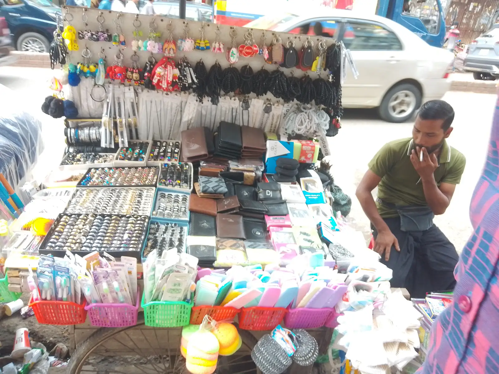 A street cosmetics stall in Bangladesh, its shelves stacked with skincare and beauty products.
